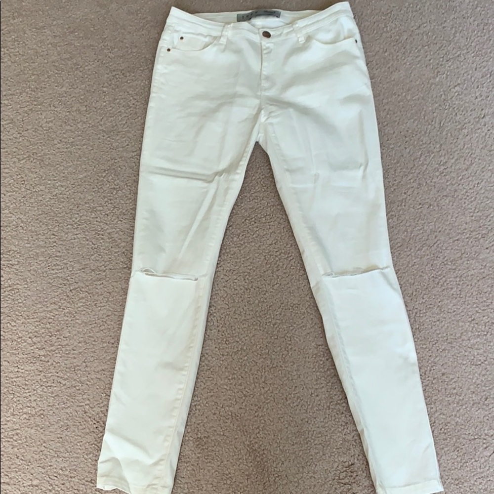 Distressed white jeans